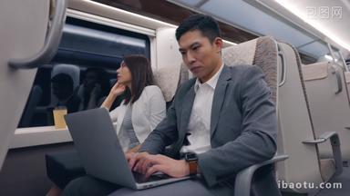 商务人士在高铁上使用笔记本电脑